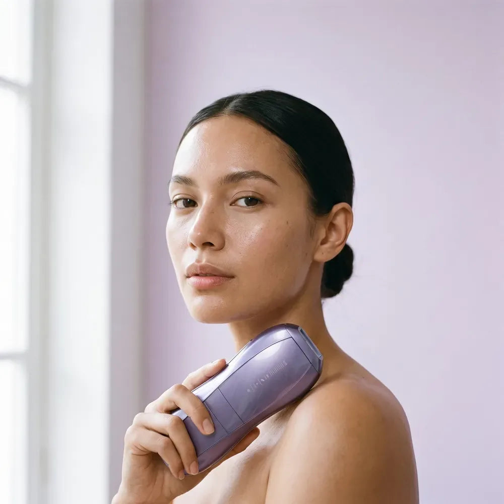 Woman with her hair pulled back holding the Air 10 at her shoulder