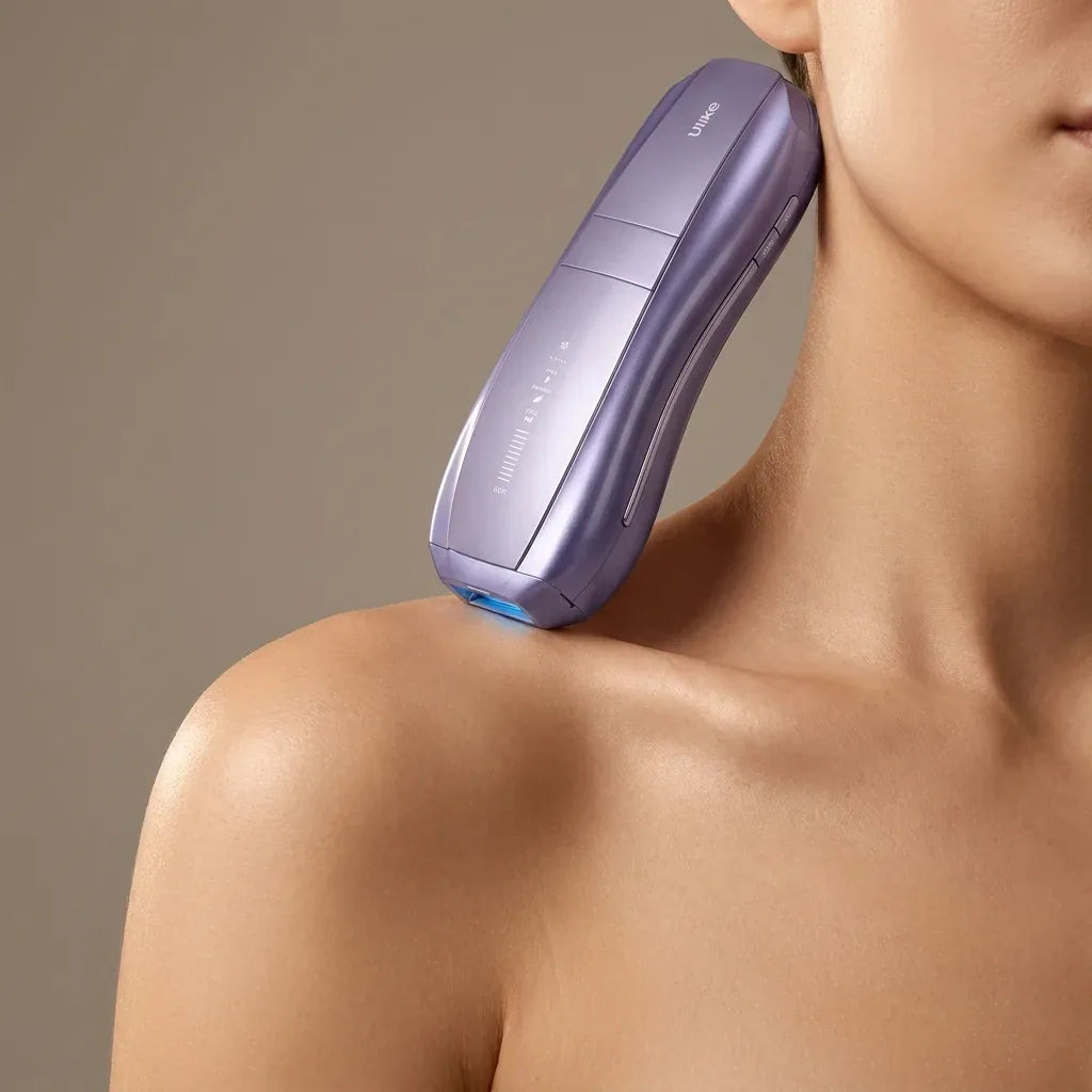 The Ulike Air 10 resting on a woman's bare shoulder against a warm taupe background