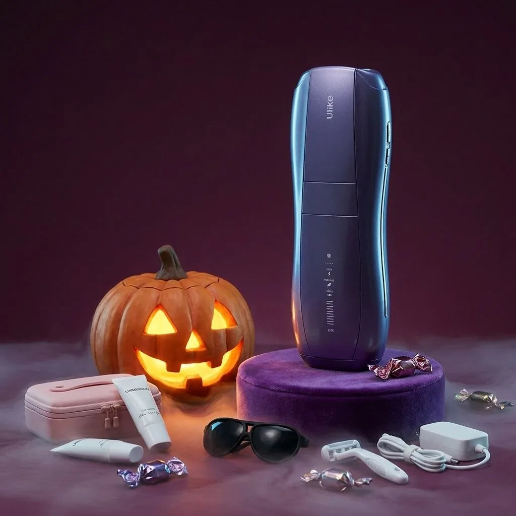 The Ulike Air 10 on a purple velvet plinth next to a carved pumpkin, a pink storage bag, aloe vera gel, IPL goggles, a razor and the charger