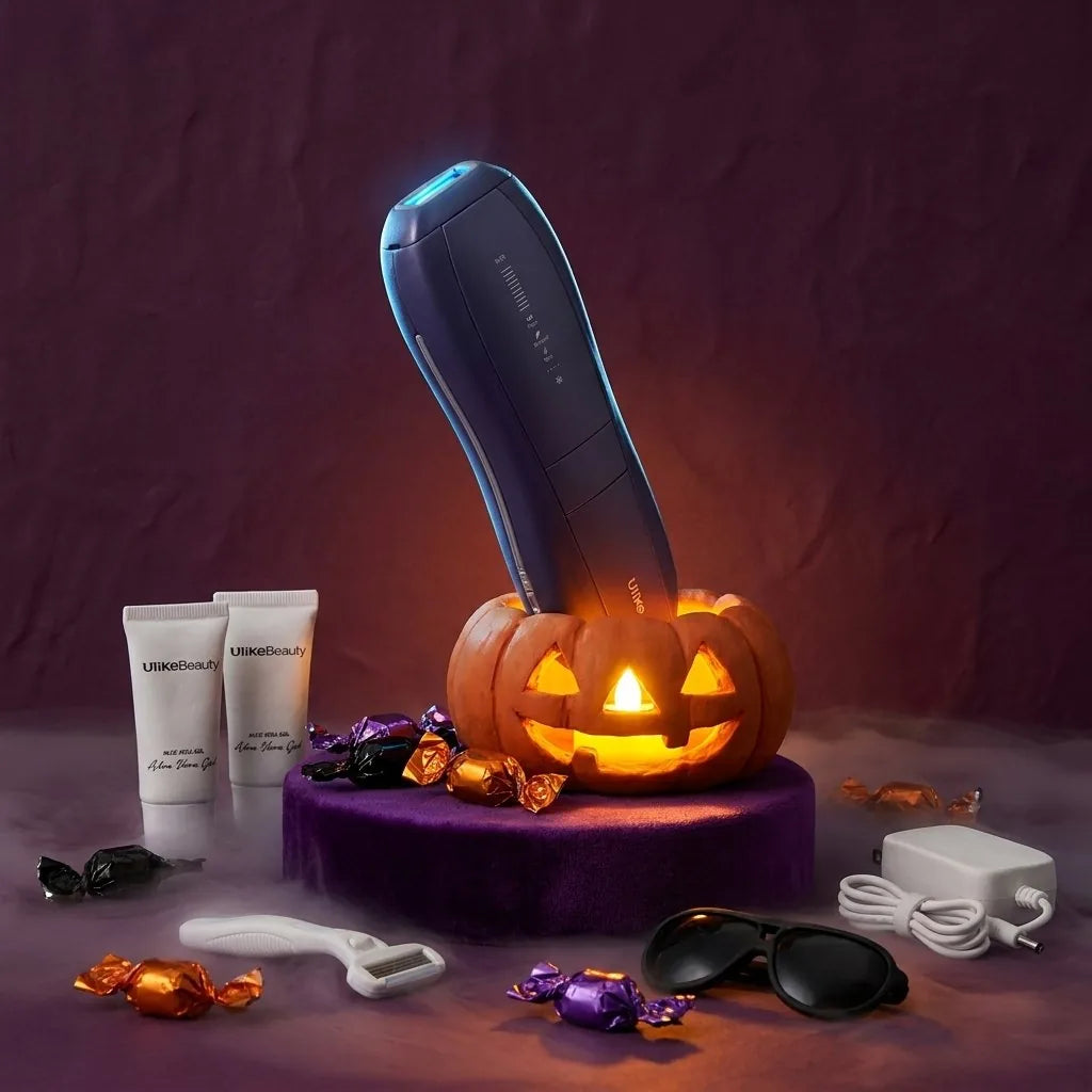The Ulike Air 10 in a glowing jack-o'-lantern on a purple velvet plinth, with aloe vera gel, a razor, IPL goggles and wrapped candy