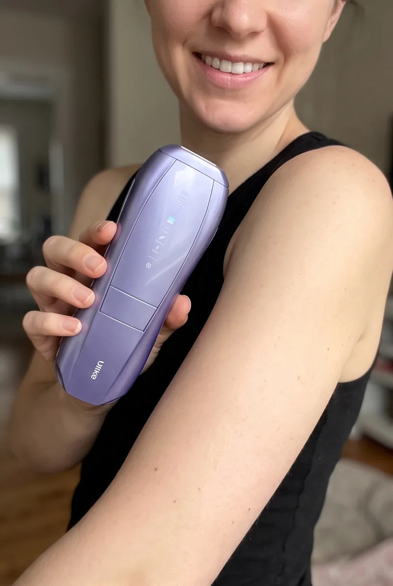 Smiling woman holding the Air 10 against her upper arm