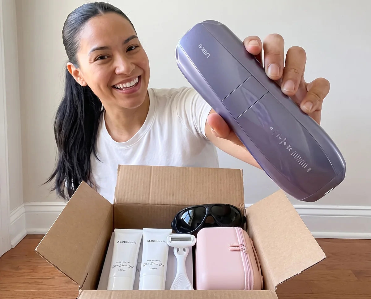 Smiling woman unboxing the Air 10 with gels, razor, goggles and storage bag